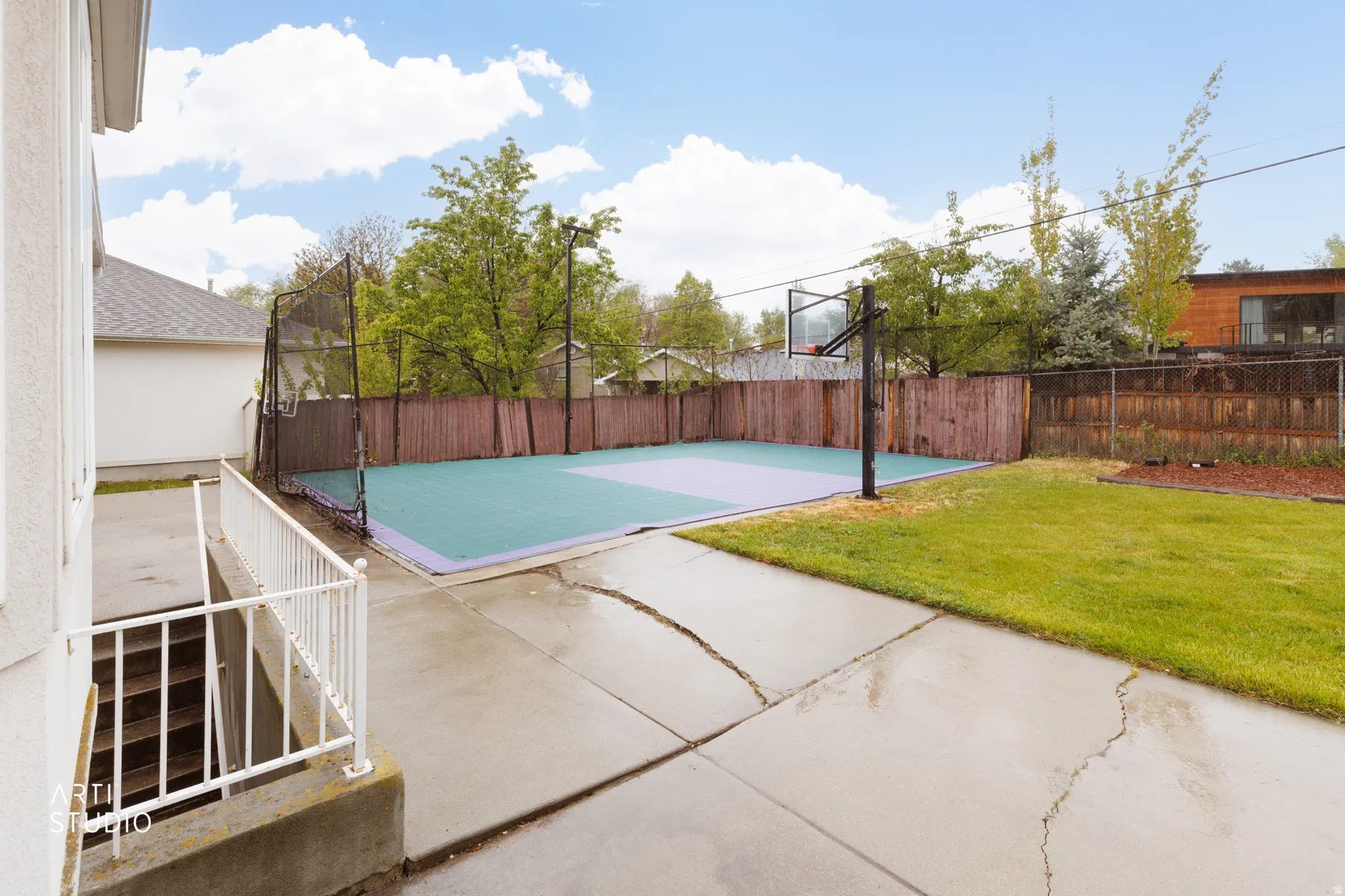 View of sport court featuring a fenced backyard, a patio area, and basketball court