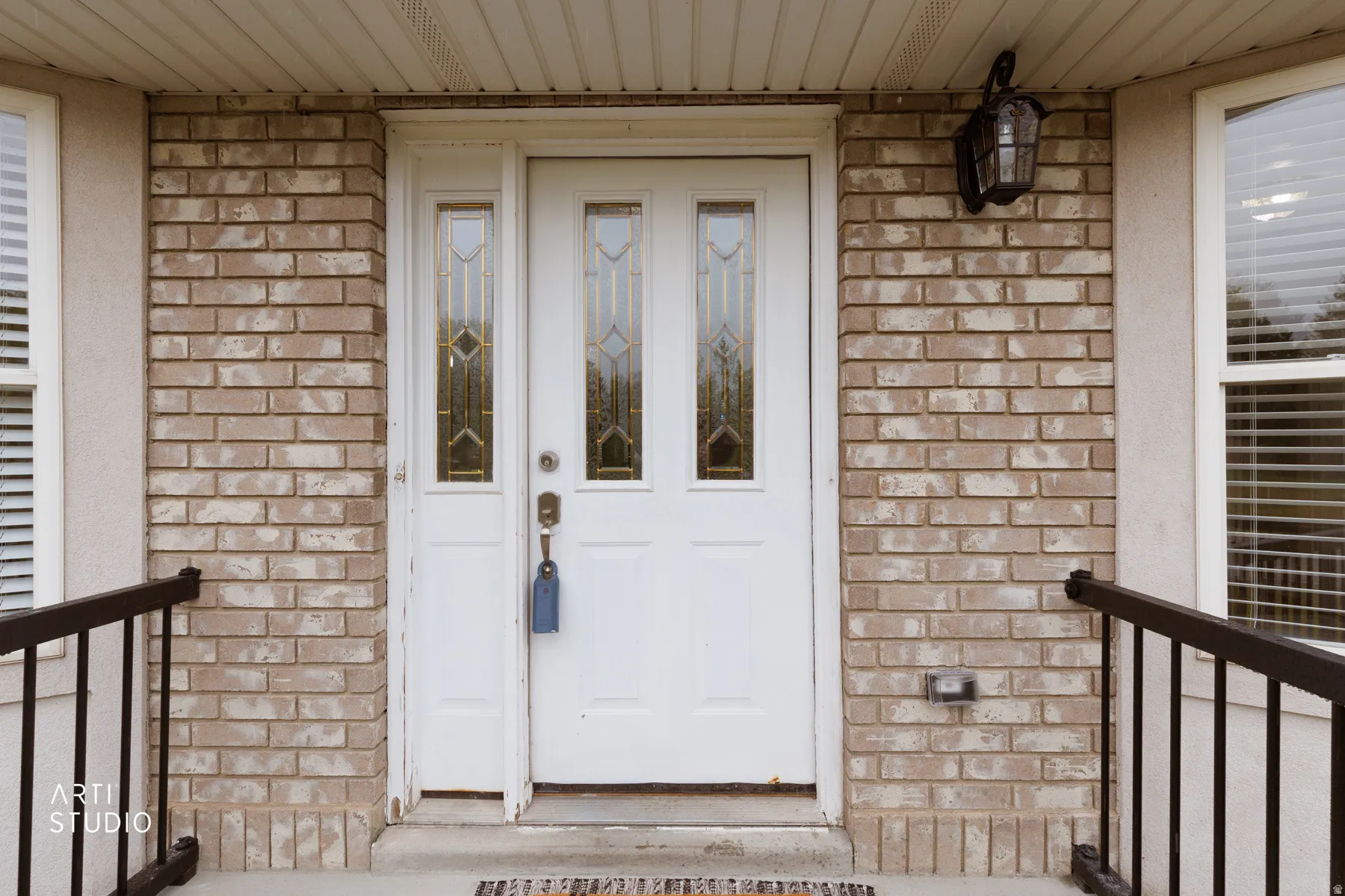 Entrance to property with brick siding