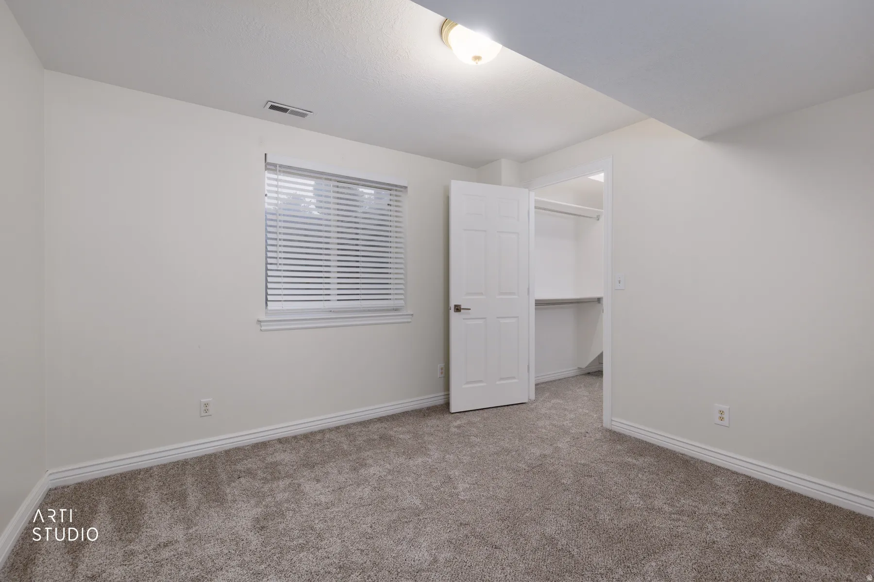 Unfurnished bedroom featuring a spacious closet and carpet floors