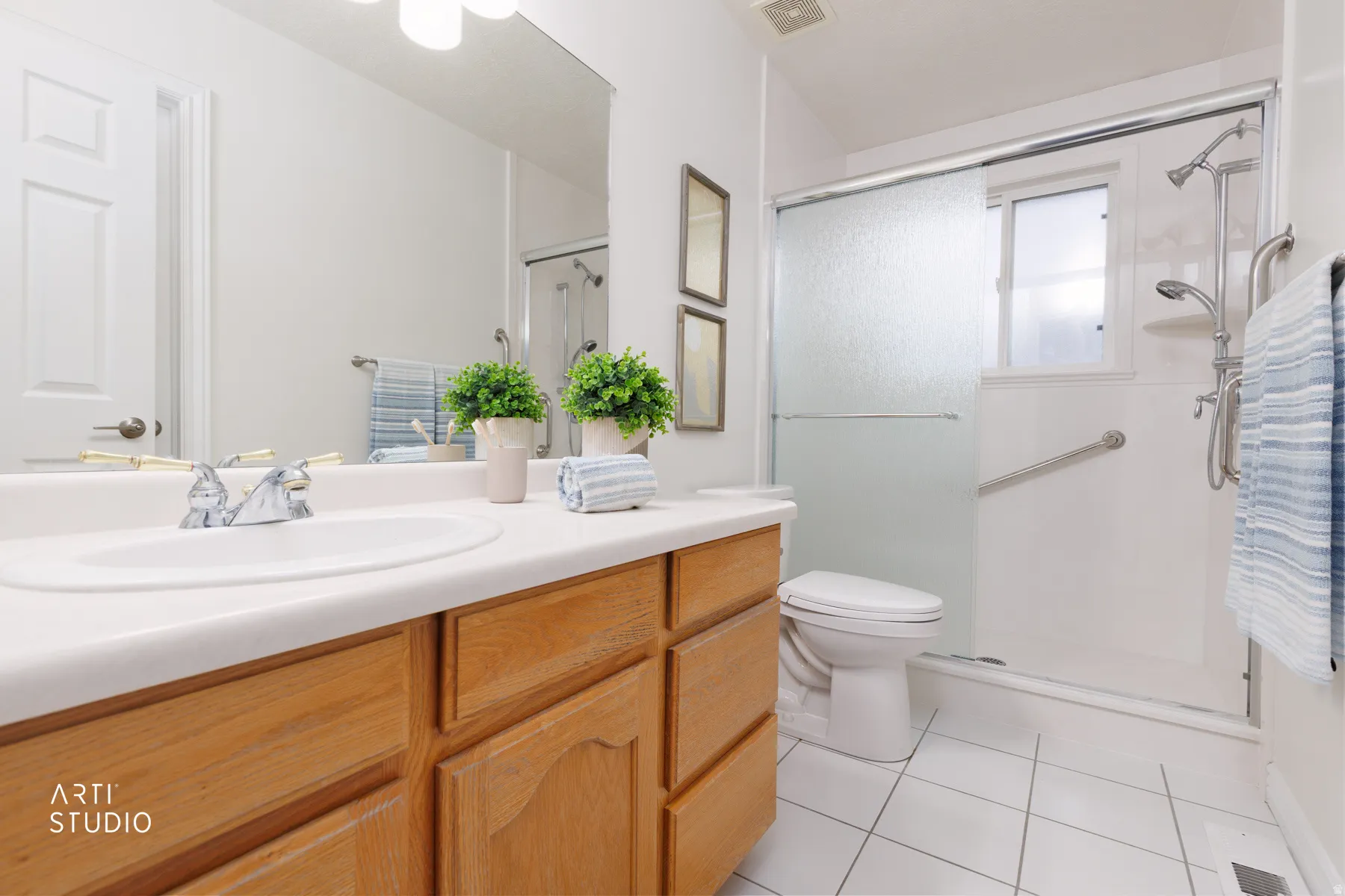 Full bathroom featuring vanity, a stall shower, and light tile patterned floors