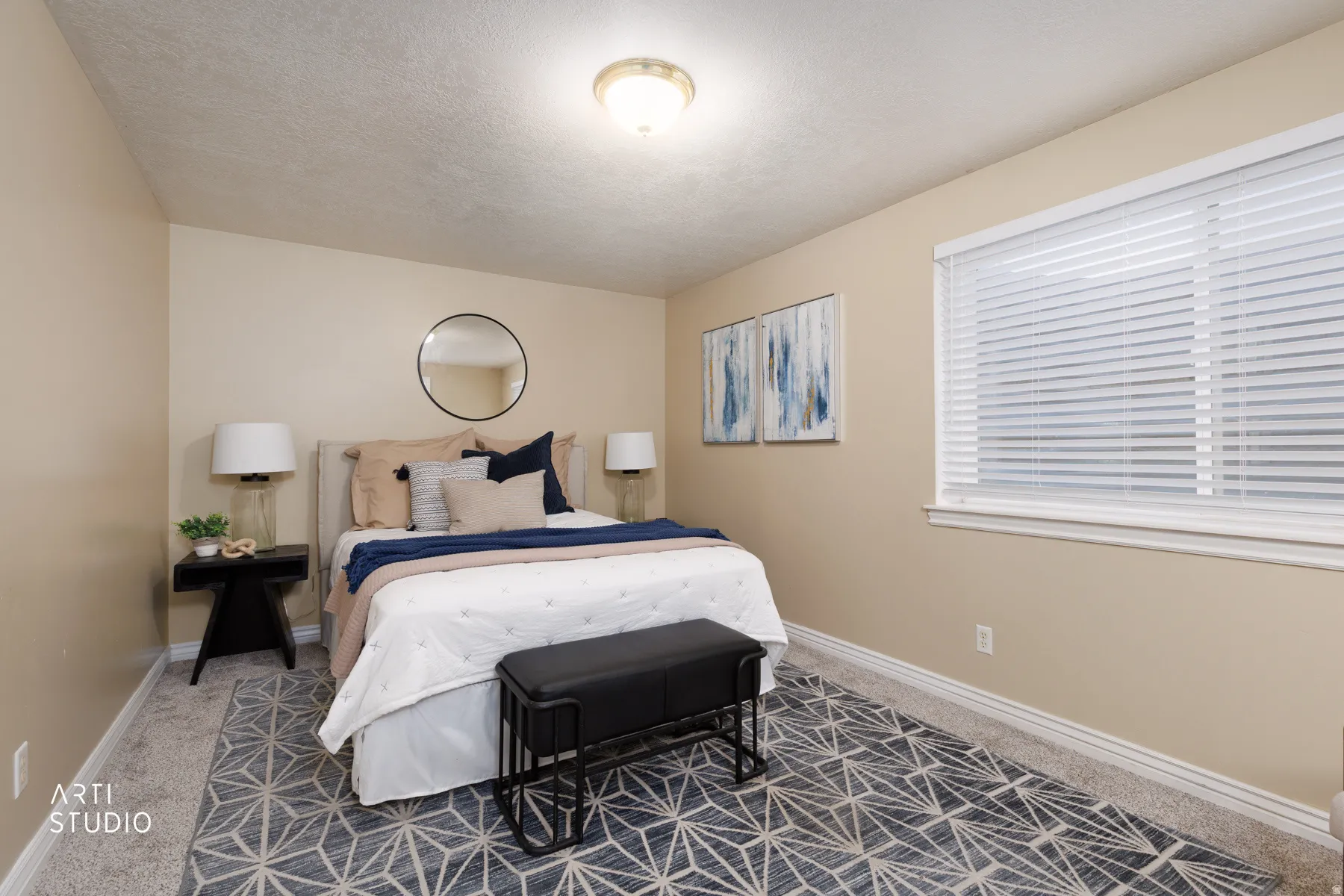 Carpeted bedroom with baseboards and a textured ceiling