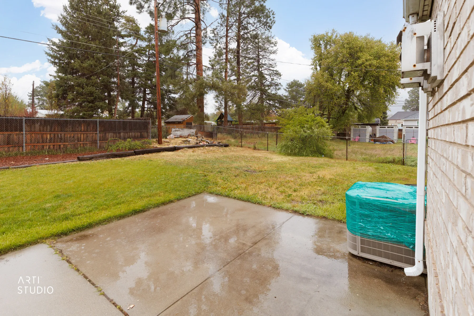 Fenced backyard with a patio area