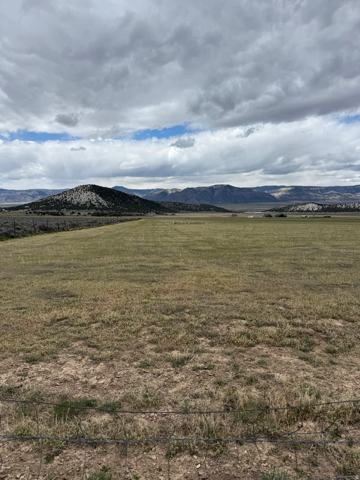 View of mountain backdrop with rural landscape