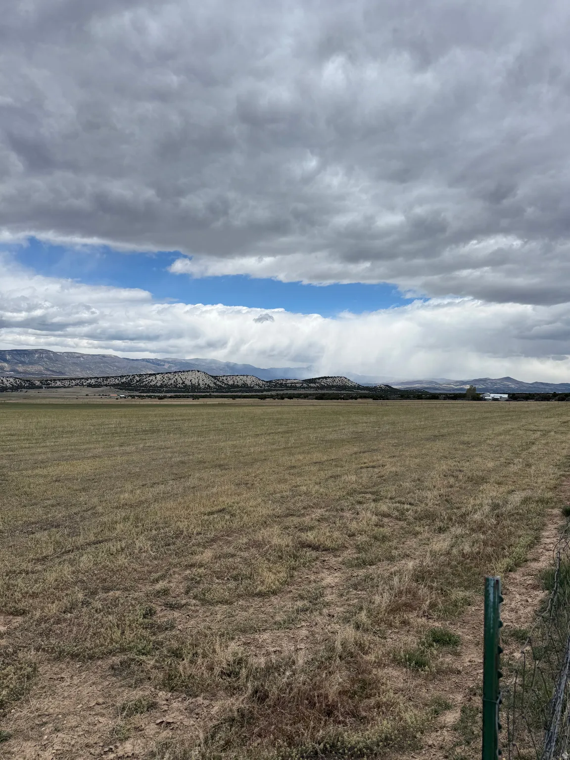 View of grassy yard with a mountain view and a rural view