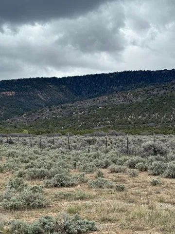 View of mountain background featuring rural landscape