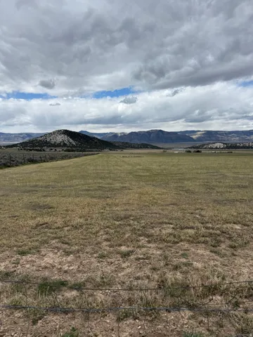 View of mountain backdrop with rural landscape