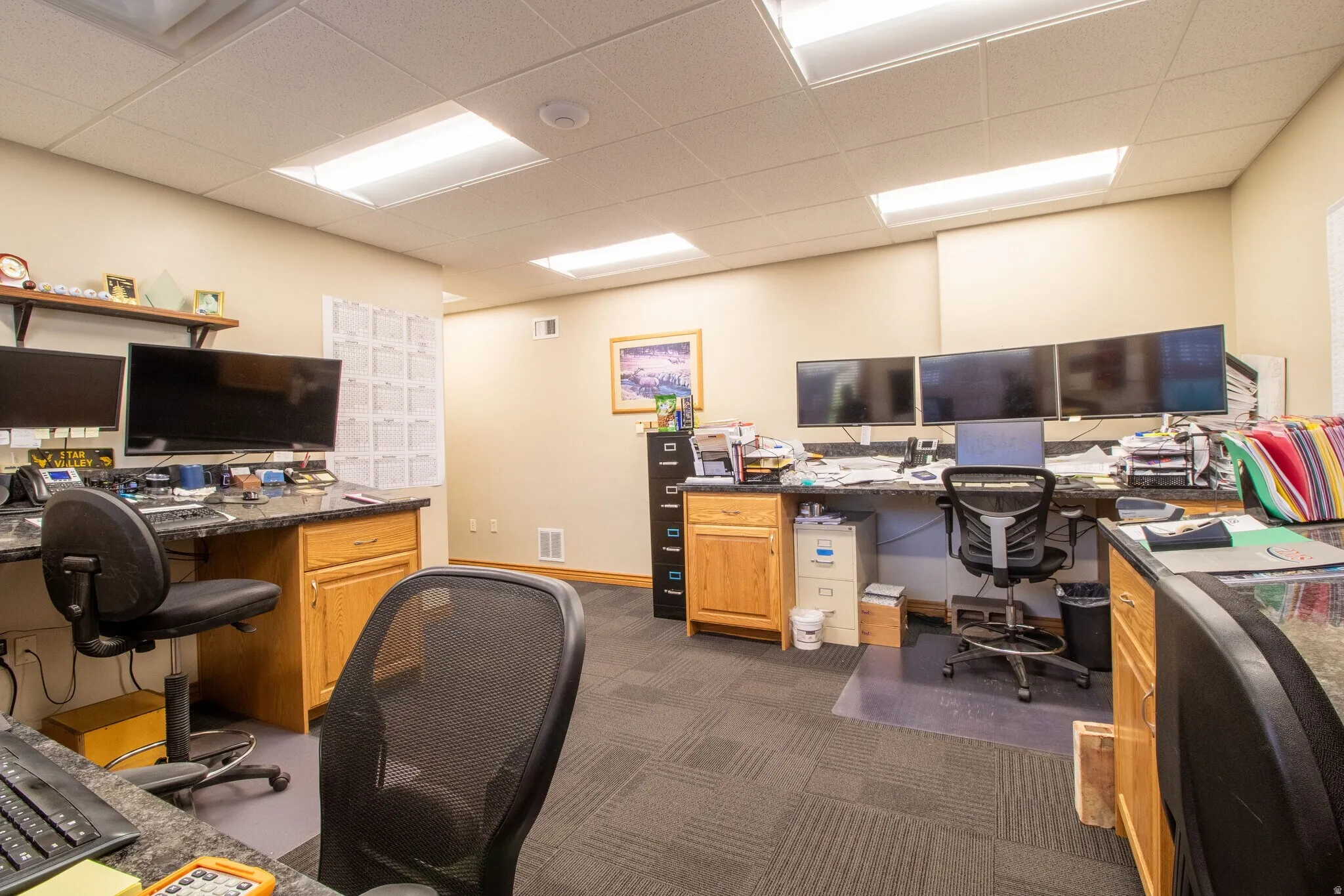 Office space with a paneled ceiling