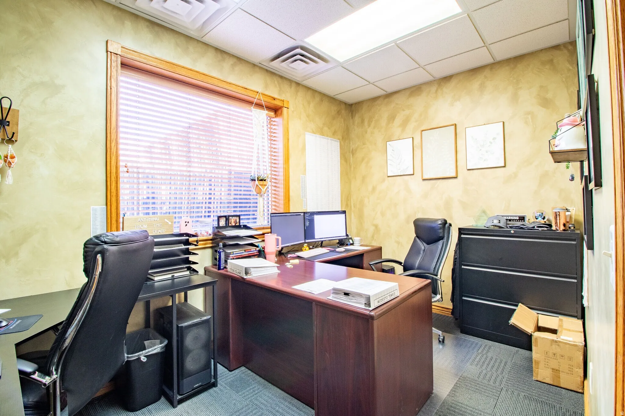 Office area with a paneled ceiling