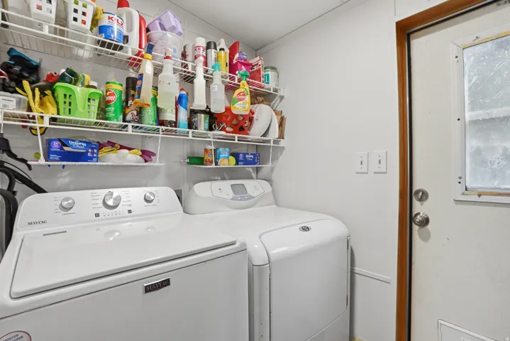 Laundry room with washer and dryer and ornamental molding