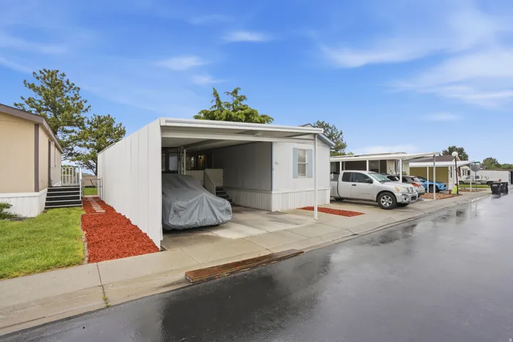View of parking featuring a carport