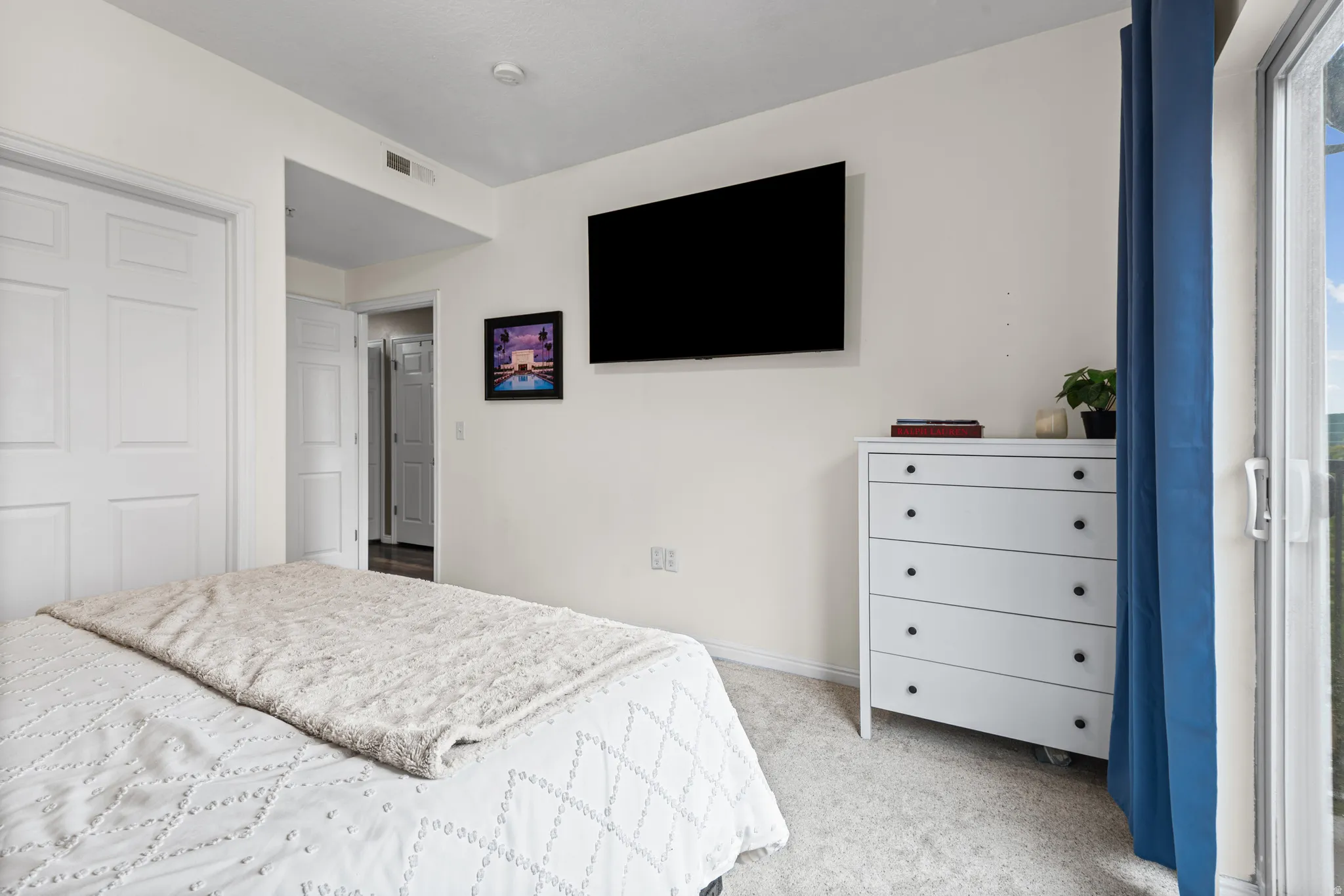 Bedroom featuring light colored carpet and baseboards