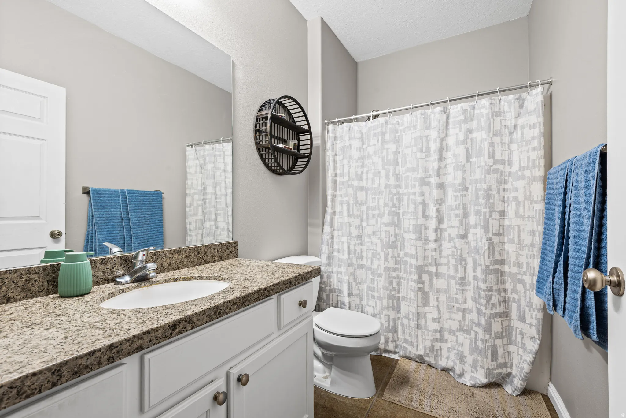 Bathroom with vanity and a shower with shower curtain