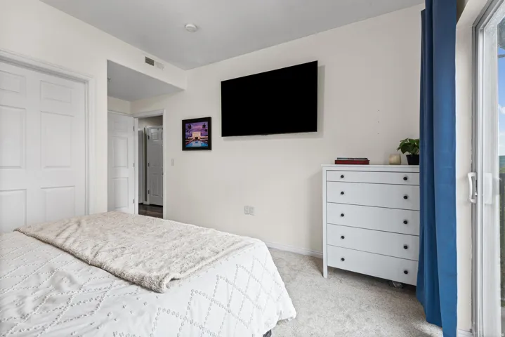 Bedroom featuring light colored carpet and baseboards