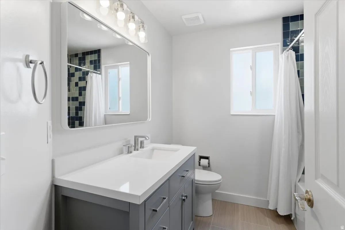 Full bathroom featuring vanity and a shower with curtain