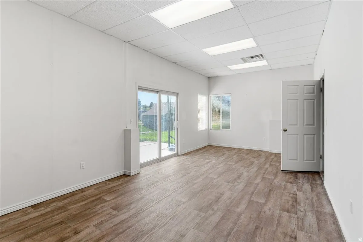 Empty room featuring a paneled ceiling and light wood finished floors
