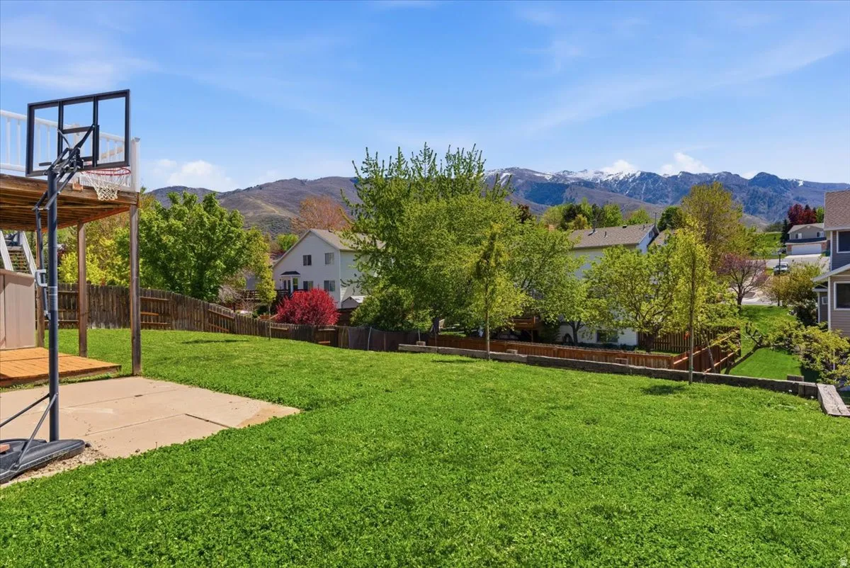 Fenced backyard with a mountain view and a patio
