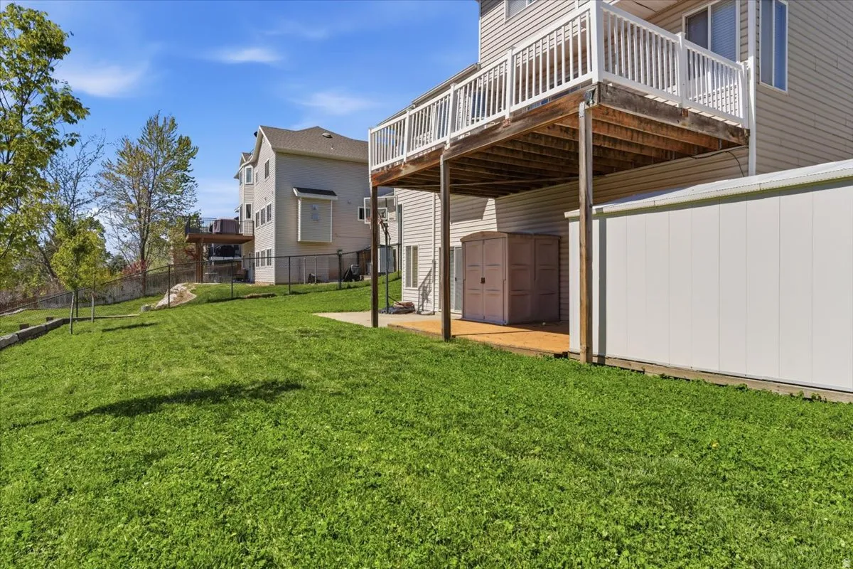 Fenced backyard with a deck and a shed
