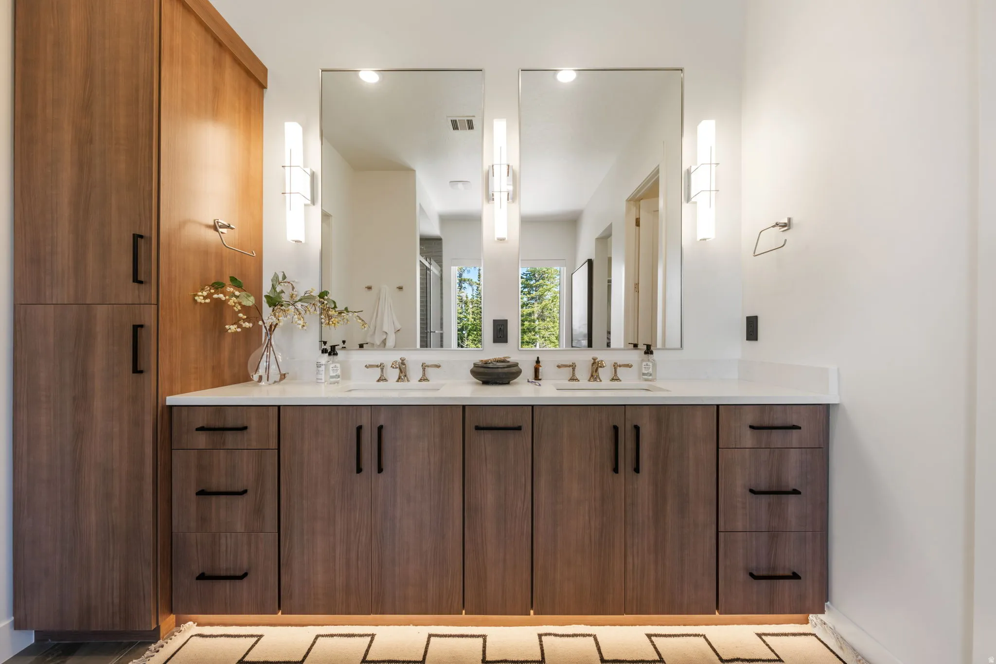 Bathroom with double vanity, a stall shower, and recessed lighting