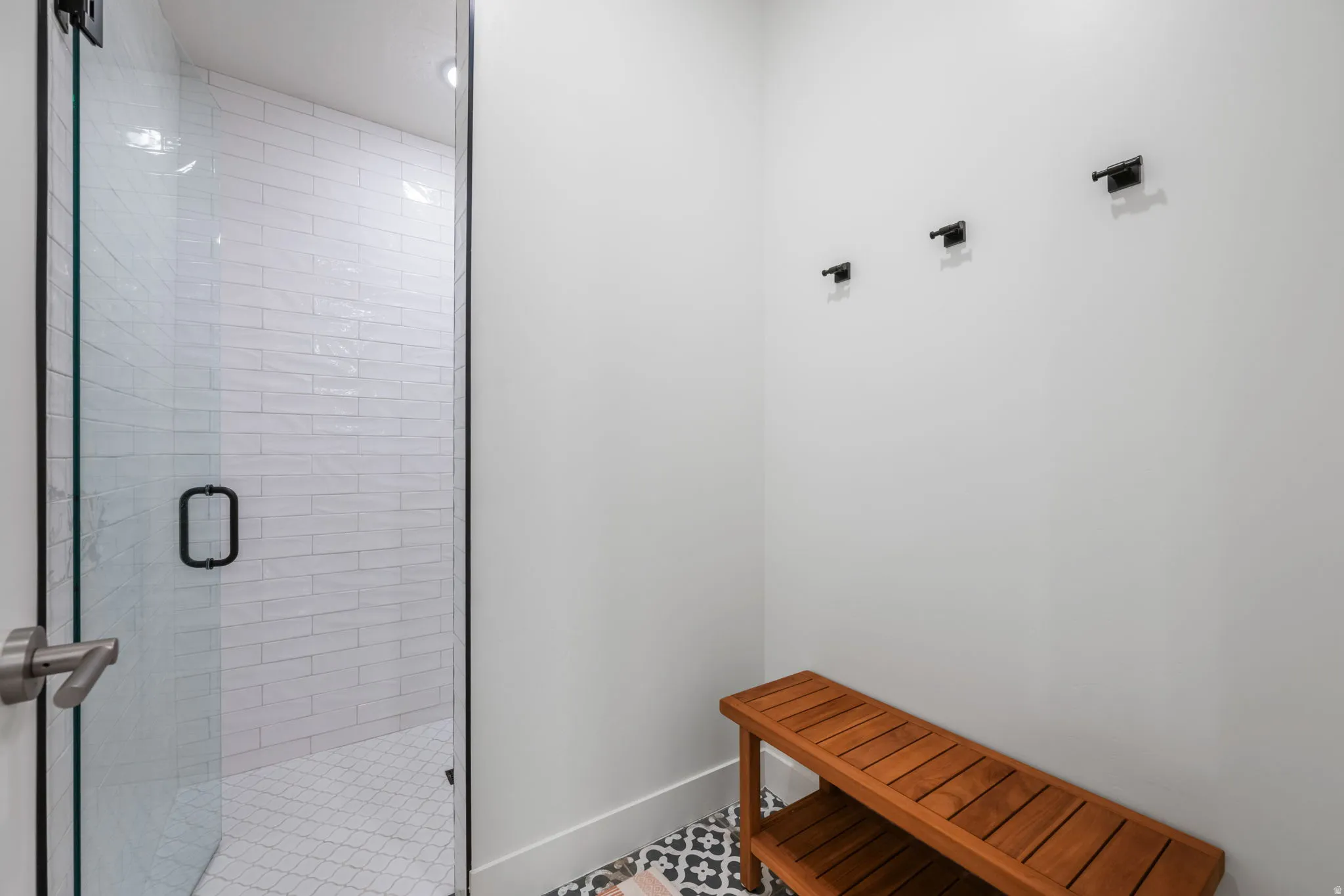 Bathroom with a stall shower and baseboards
