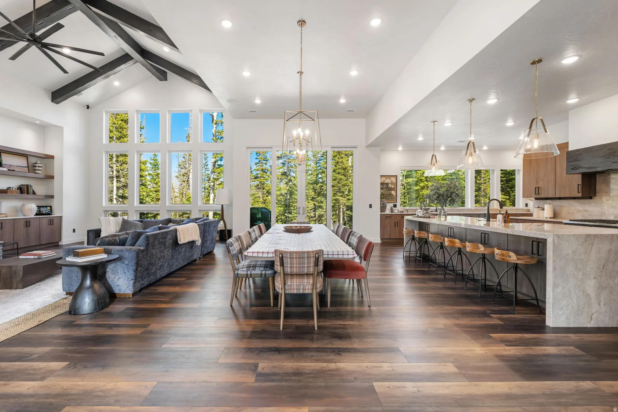 Dining room with suspended lighting, dark wood-style floors, and vaulted ceiling
