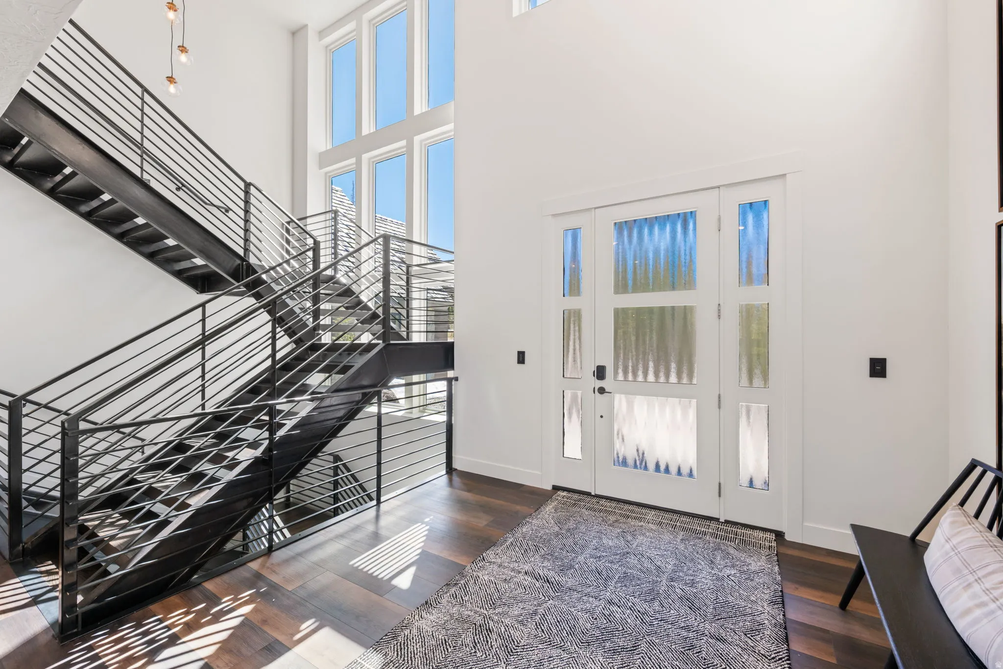 Entrance foyer featuring dark wood-style flooring and a high ceiling