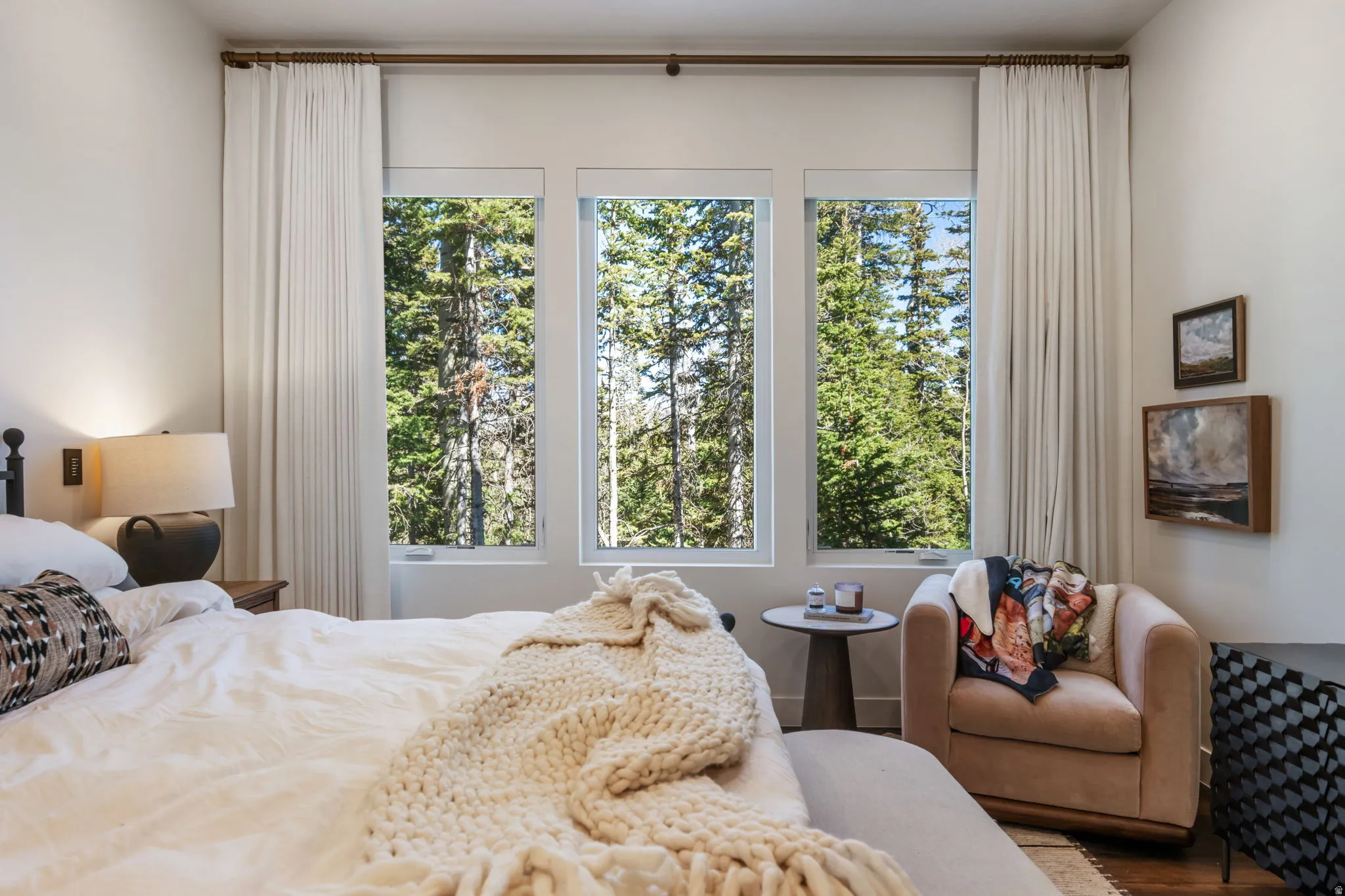 Bedroom with multiple windows and wood finished floors