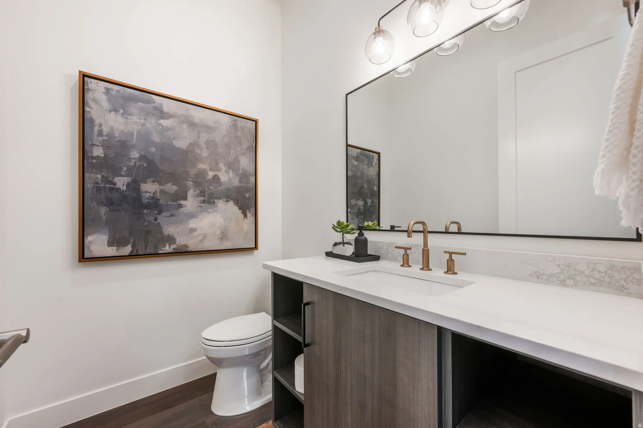 Bathroom with vanity and dark wood-style flooring