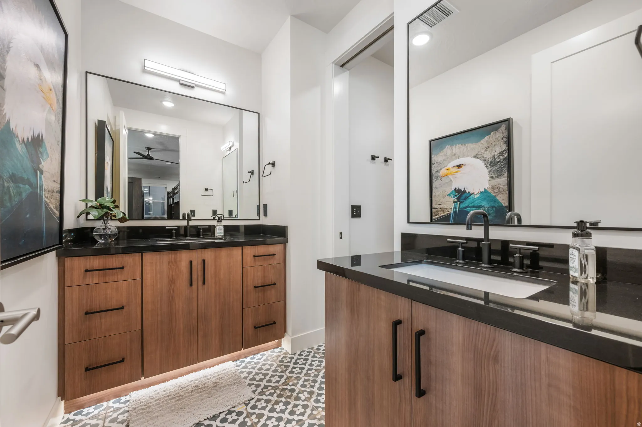 Full bath with two vanities and a ceiling fan