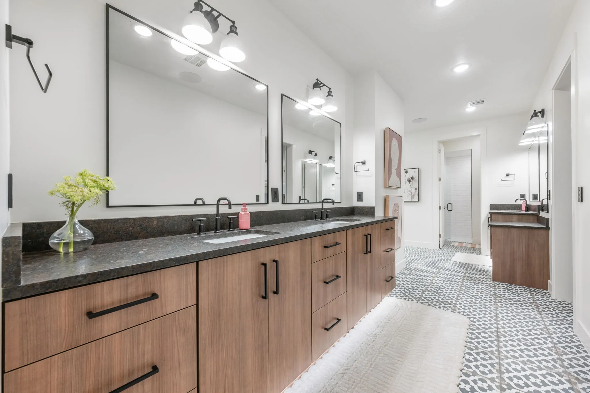 Full bathroom featuring double vanity, a stall shower, and recessed lighting