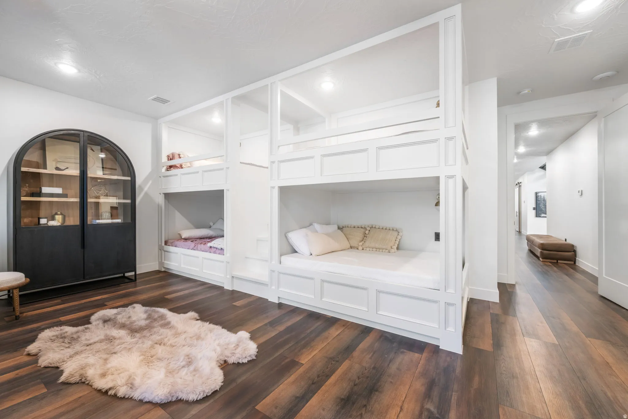 Bedroom featuring dark wood finished floors and baseboards