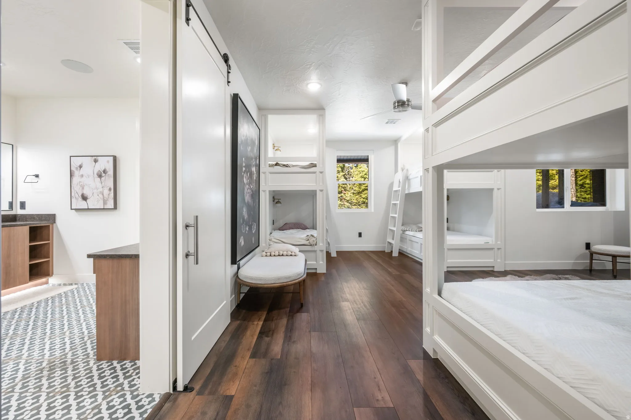Bedroom featuring dark wood-type flooring and a barn door