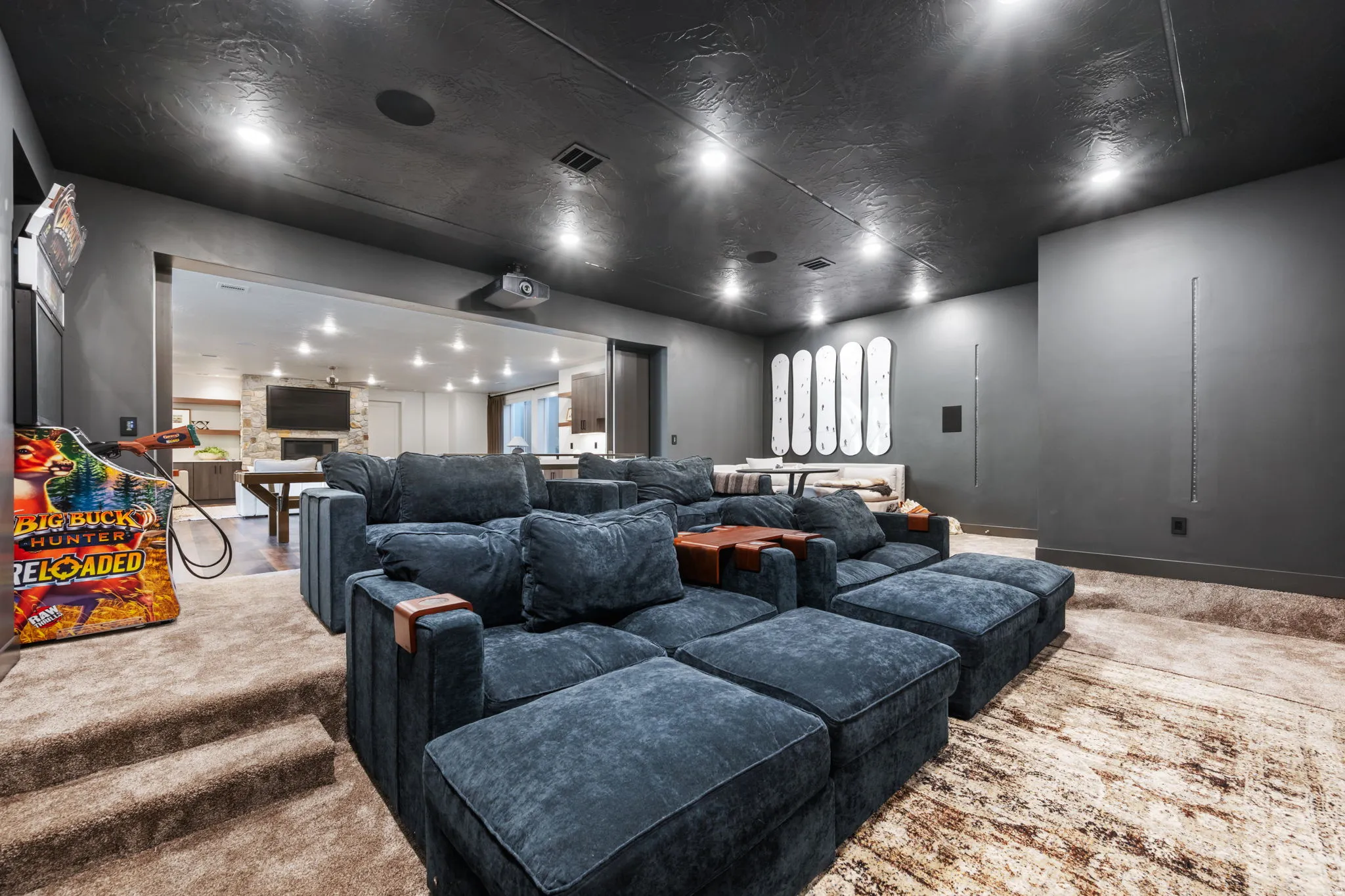 Carpeted home theater room featuring a fireplace