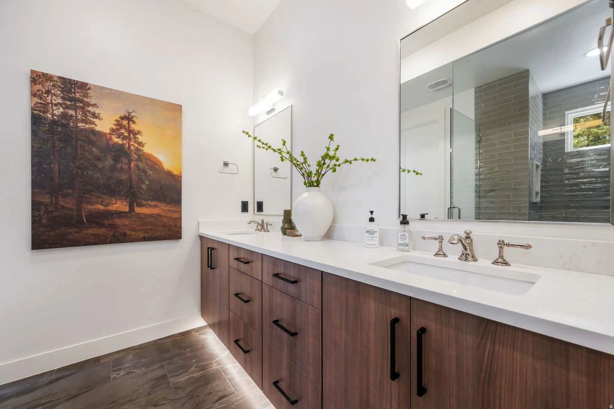 Bathroom with double vanity and a shower stall