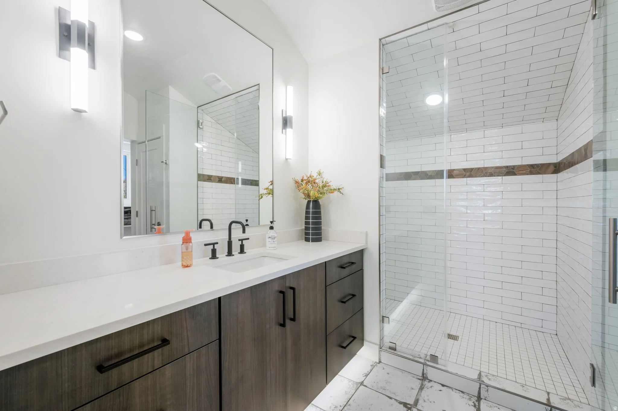 Bathroom with vanity and a shower stall