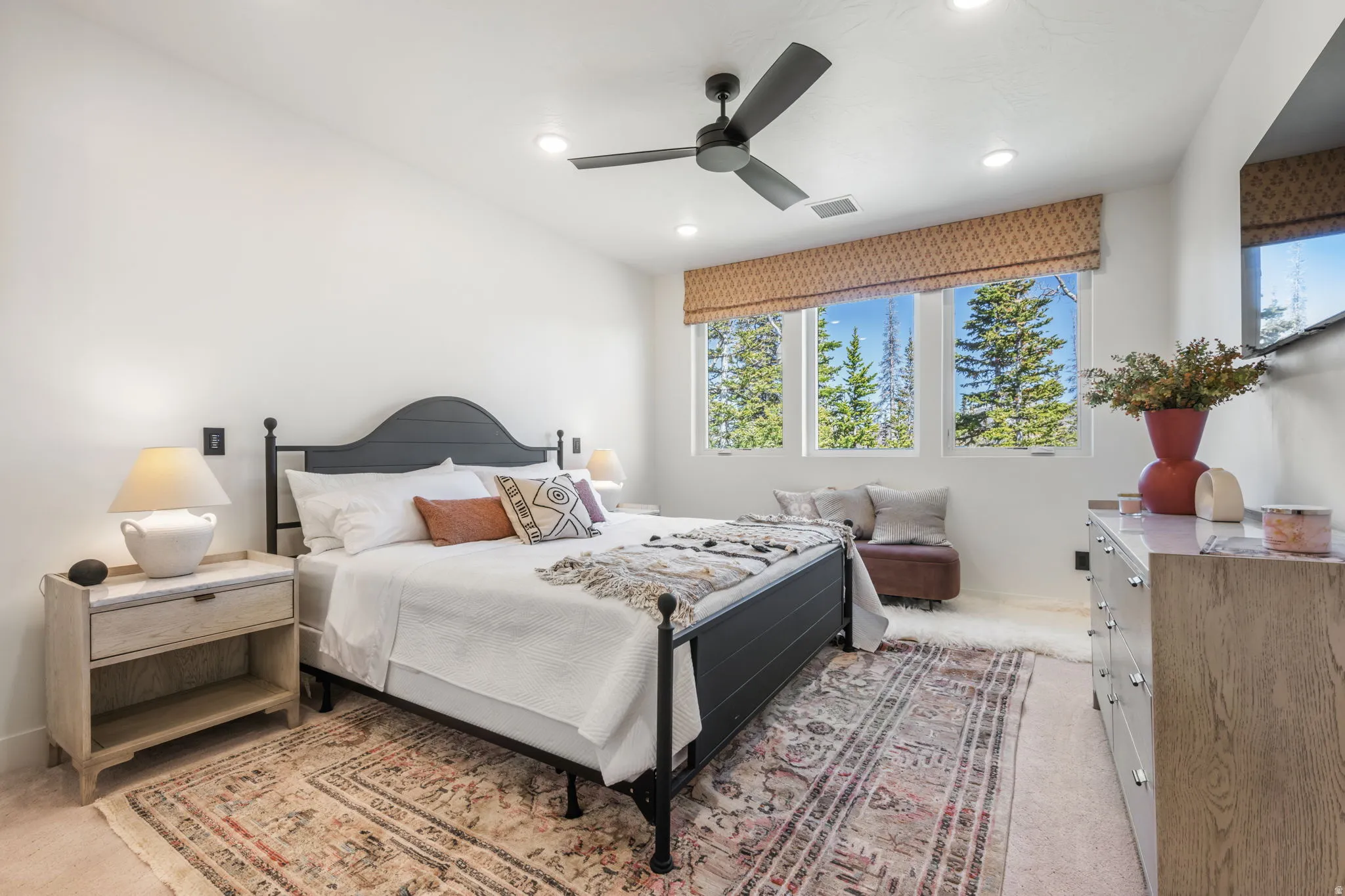 Bedroom with light carpet, ceiling fan, and recessed lighting