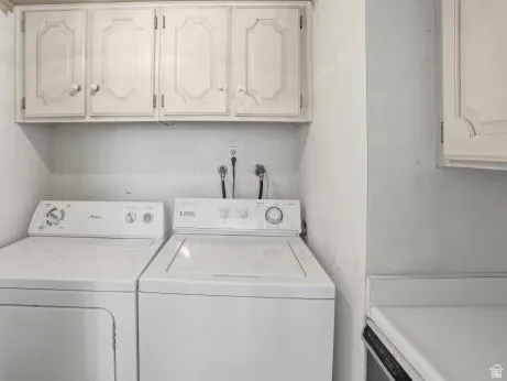 Laundry room featuring washing machine and dryer and cabinet space