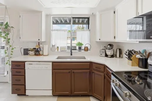 Kitchen with two tone color scheme, stainless steel appliances, and light countertops