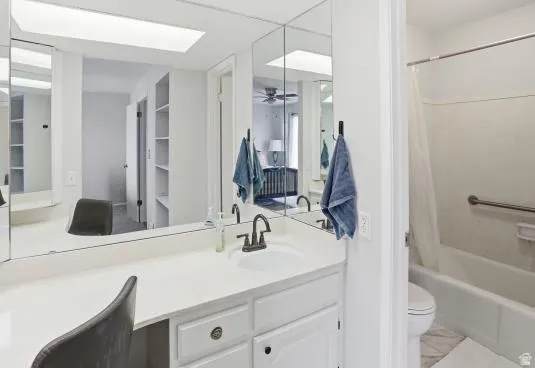 Full bathroom featuring vanity and shower / bath combo with shower curtain