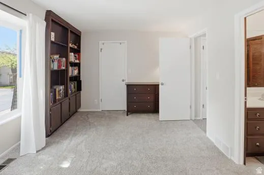 Bedroom featuring light carpet