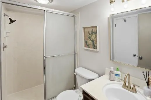 Bathroom featuring vanity and a shower stall