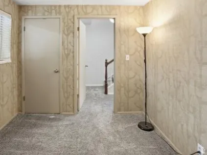 Hall with light colored carpet