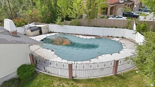 View of swimming pool with a fenced backyard and patio surround