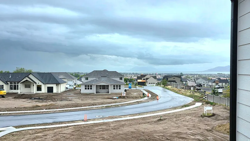 View of asphalt street featuring a residential view, sidewalks, and curbs
