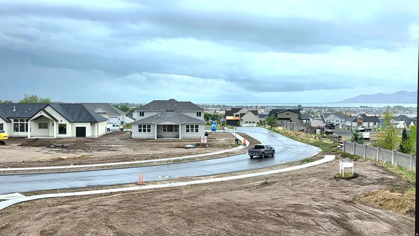 View of asphalt street featuring sidewalks and a residential view