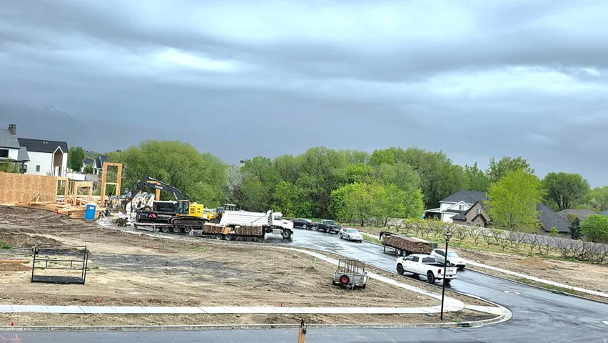 View of asphalt street featuring sidewalks and curbs