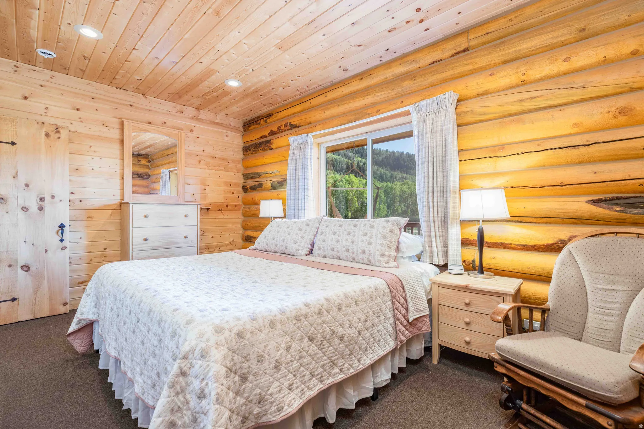 Bedroom featuring dark carpet, wood ceiling, log walls, and recessed lighting