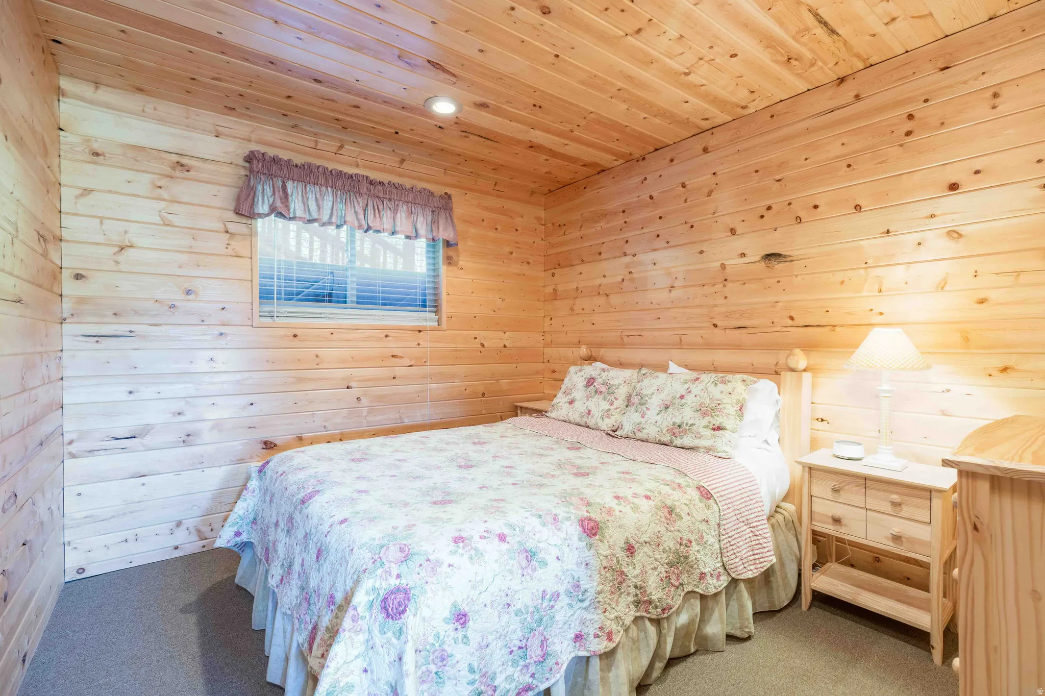 Bedroom featuring wooden walls, carpet flooring, wooden ceiling, and recessed lighting