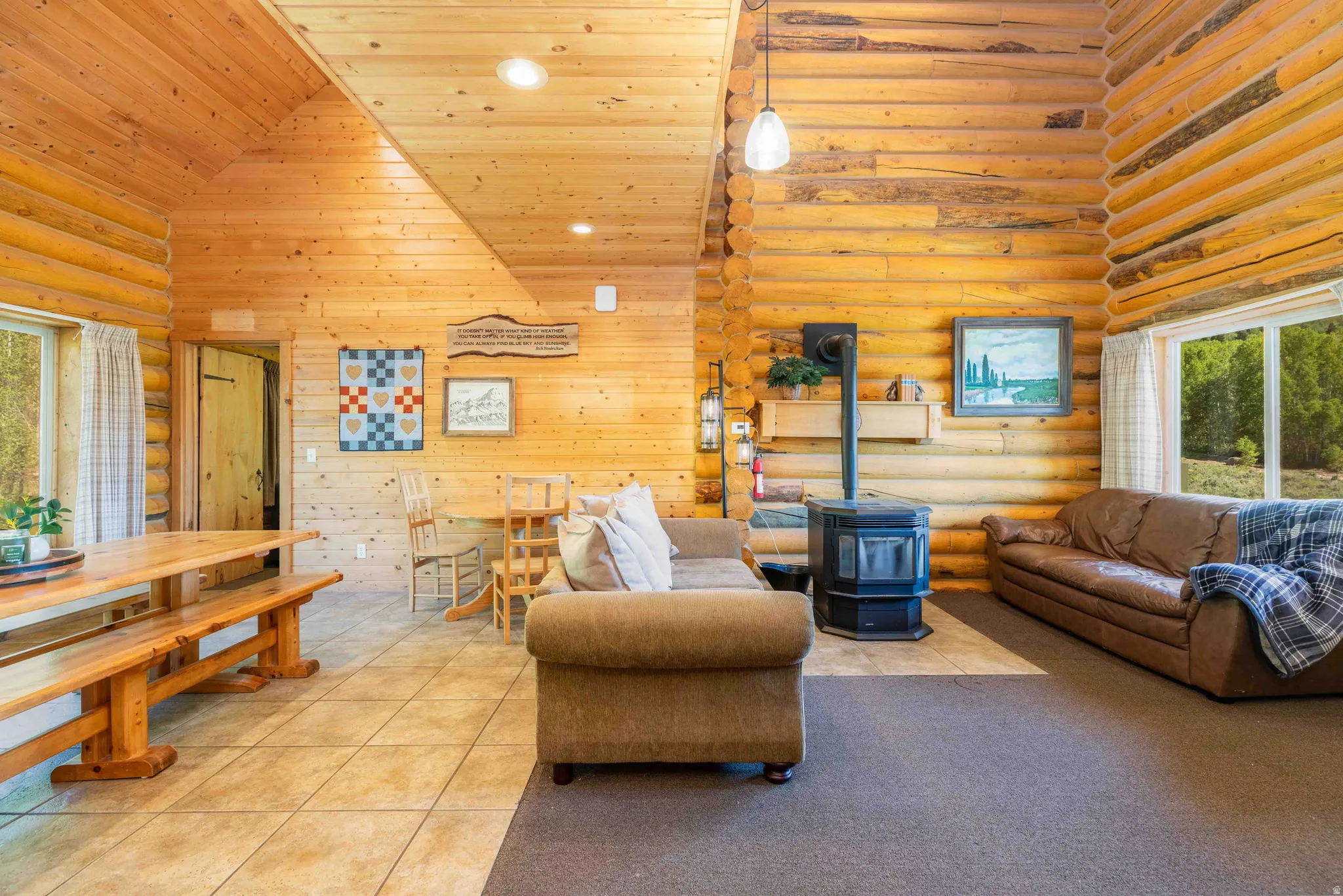 Living area featuring log walls, a wood stove, recessed lighting, a vaulted wood ceiling, and carpet floors