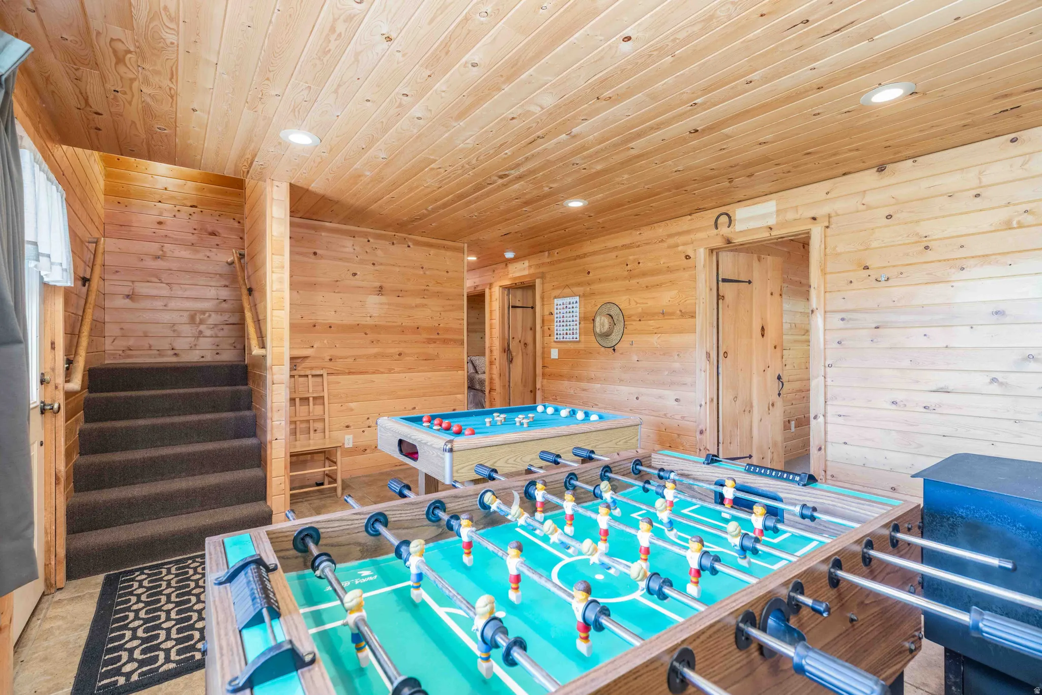 Rec room featuring wooden walls, wooden ceiling, and recessed lighting