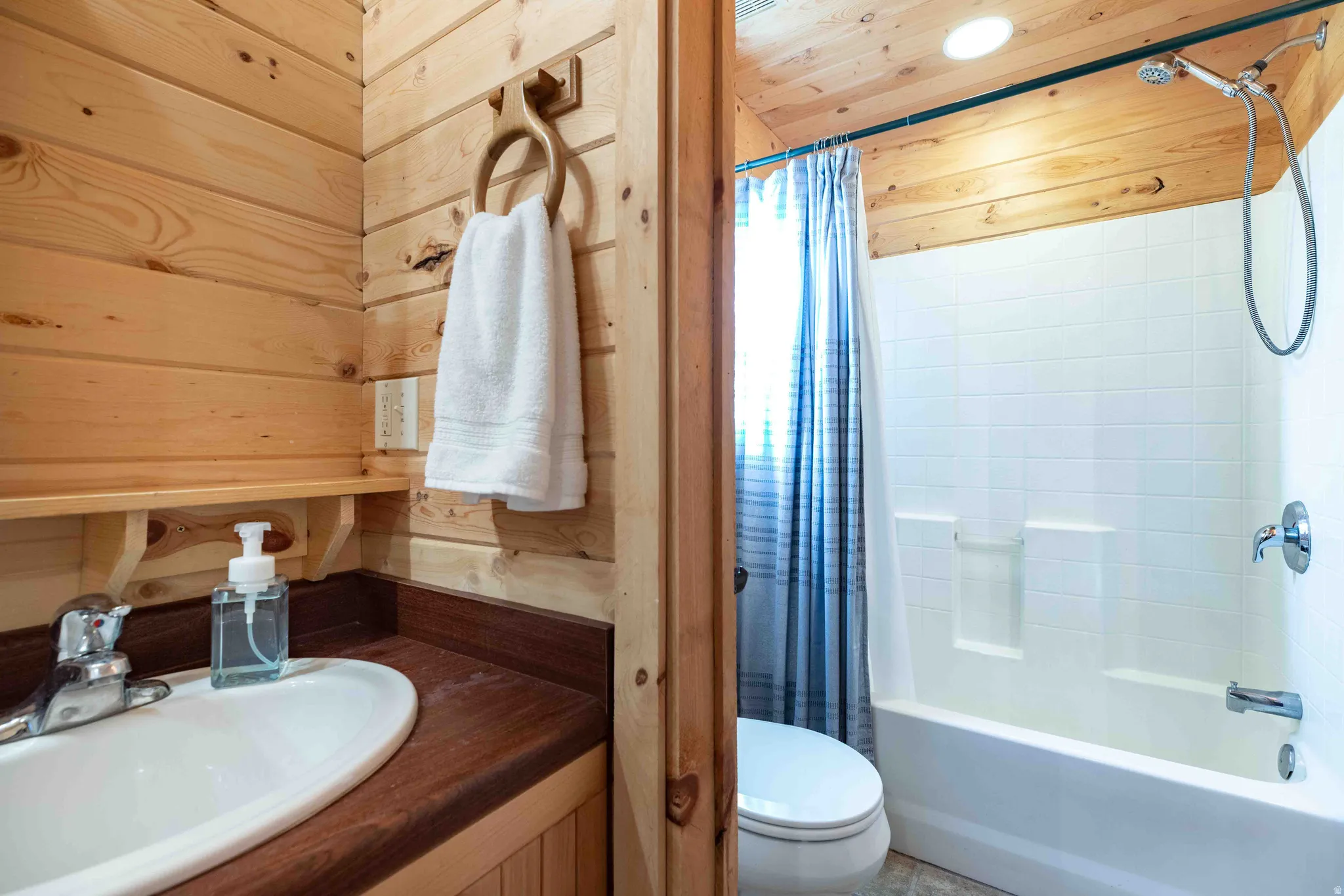 Bathroom with vanity, shower / tub combo, and wood ceiling